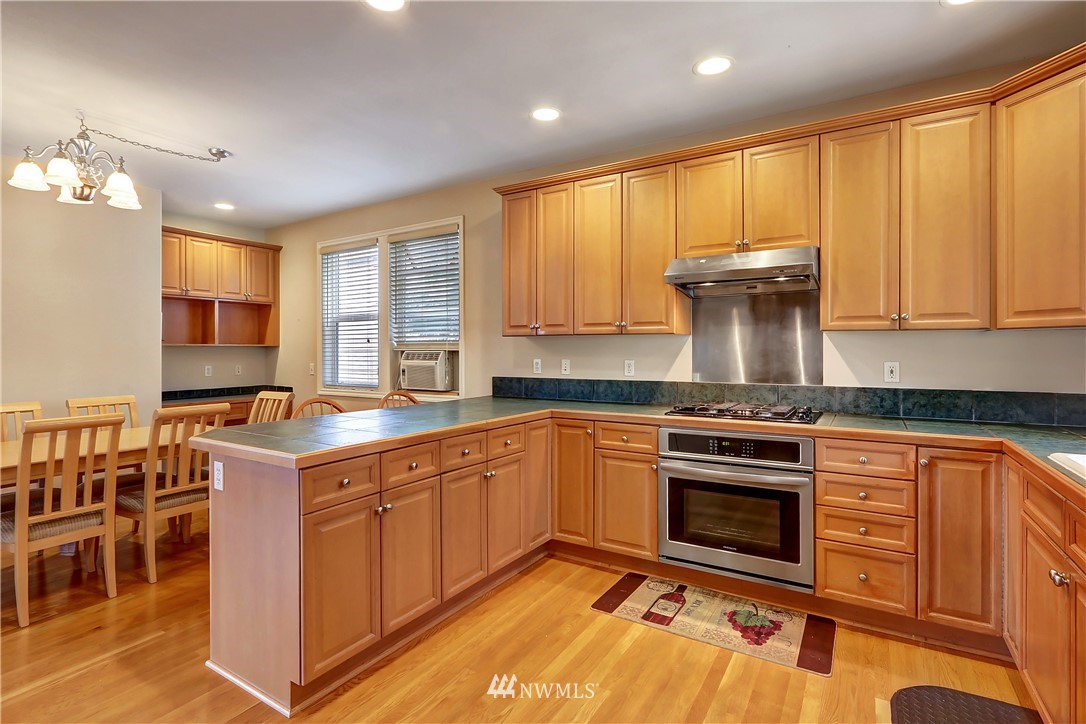 17013 Parkside Way Southeast Renton, WA 98058 - Photo 6 of 26 a kitchen with a stove a sink and a microwave