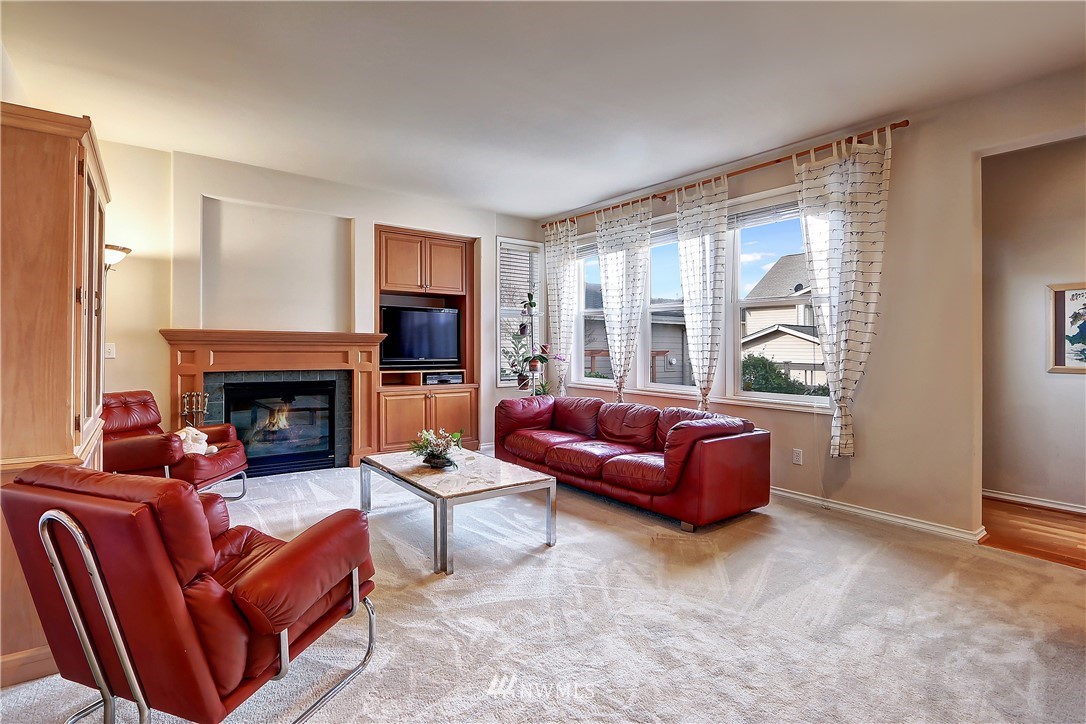 17013 Parkside Way Southeast Renton, WA 98058 - Photo 9 of 26 a living room with furniture and a fireplace