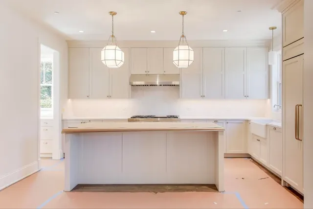 a kitchen with stainless steel appliances granite countertop a sink a stove and a refrigerator