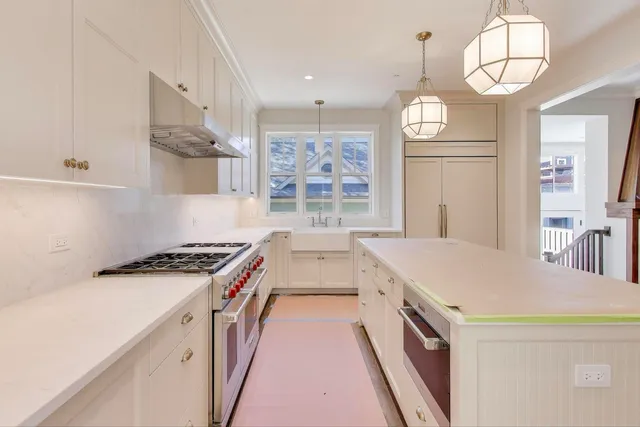 a kitchen with a stove and a chandelier