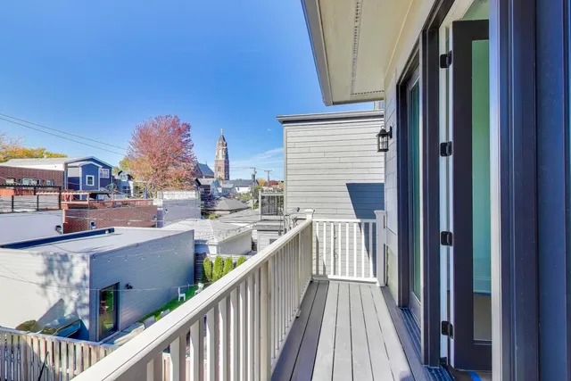 a view of balcony with wooden floor and seating space