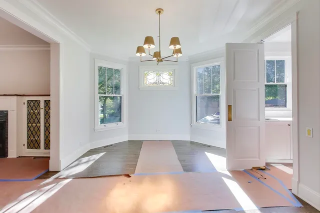 a view of a room with wooden floor and windows