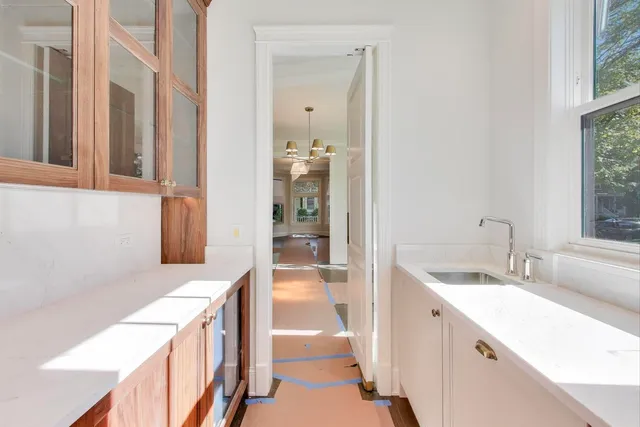 a kitchen with a sink and a refrigerator