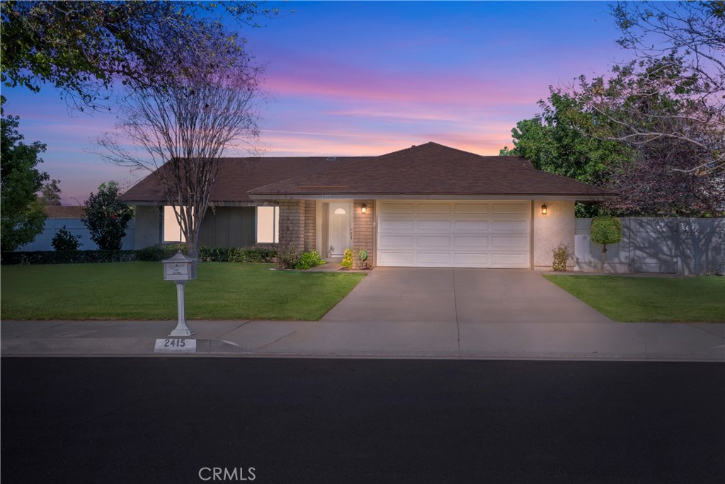2415 Peppertree Lane Riverside, CA 92506 - Photo 1 of 39 a front view of a house with a yard and garage