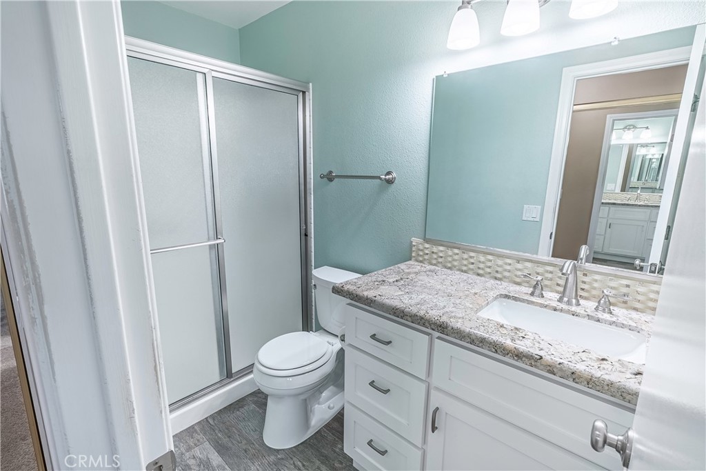 2415 Peppertree Lane Riverside, CA 92506 - Photo 23 of 39 a bathroom with a granite countertop sink toilet and shower