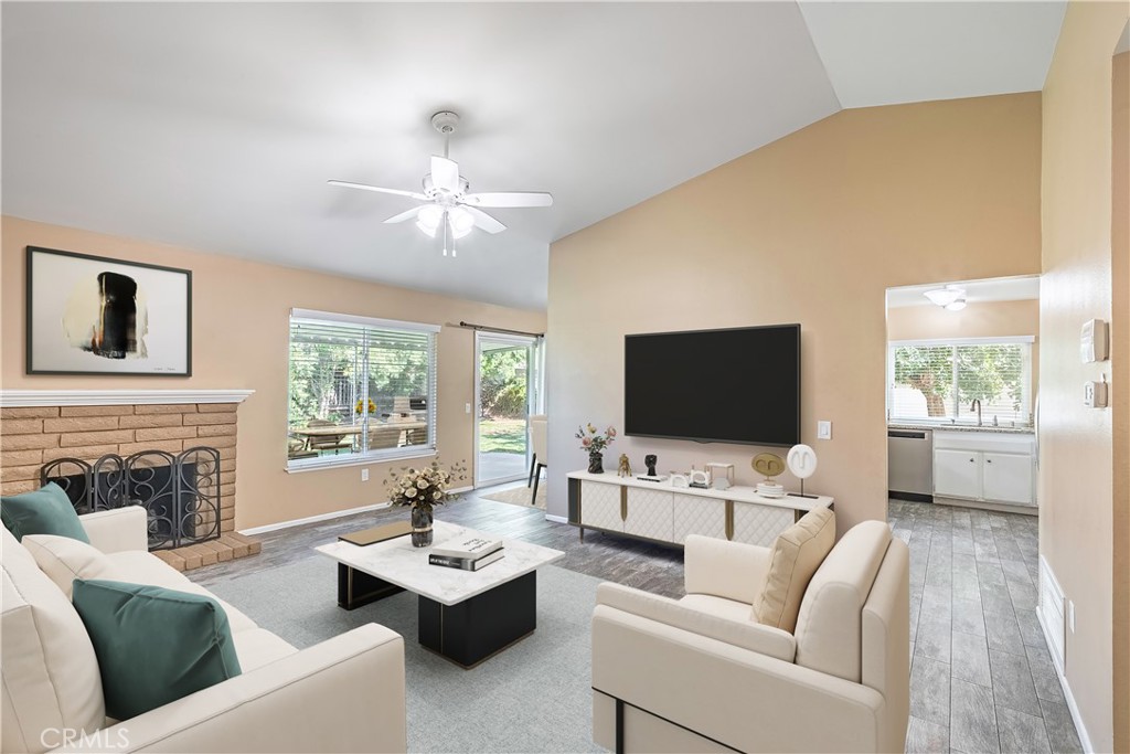 2415 Peppertree Lane Riverside, CA 92506 - Photo 3 of 39 a living room with furniture a fireplace and a flat screen tv