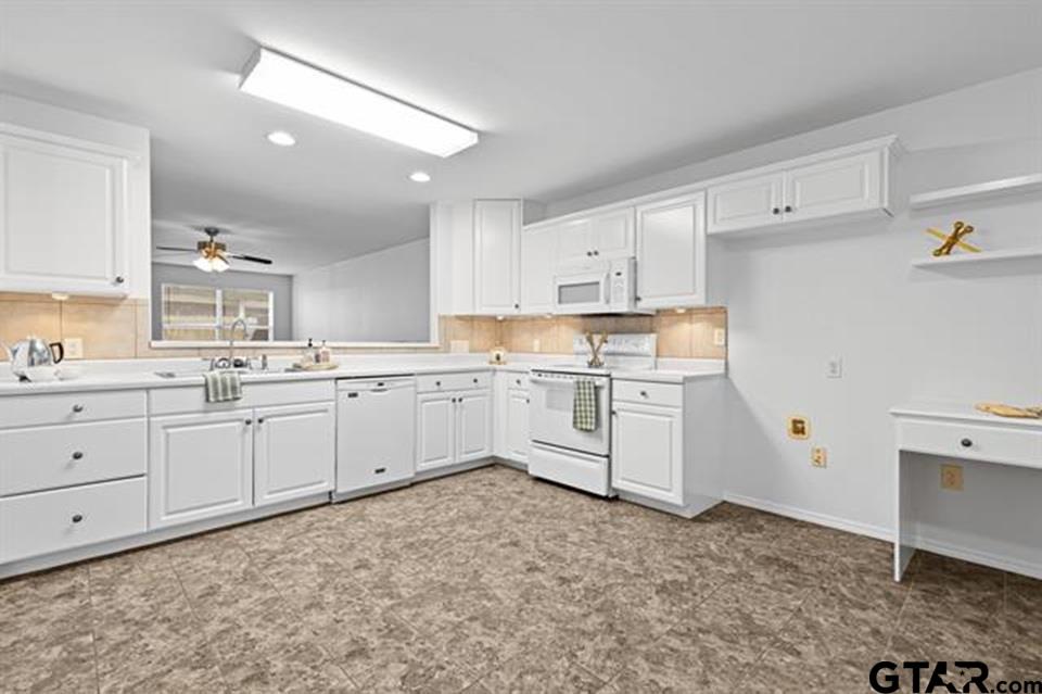 1807 Paverstone Lane Longview, TX 75605 - Photo 11 of 37 a kitchen with white cabinets and white appliances
