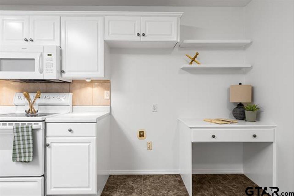 1807 Paverstone Lane Longview, TX 75605 - Photo 12 of 37 a kitchen with a sink a stove and cabinets