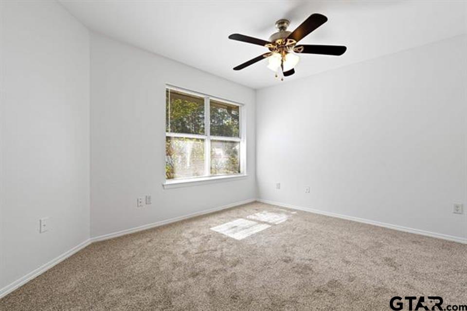 1807 Paverstone Lane Longview, TX 75605 - Photo 15 of 37 an empty room with a window and a fan