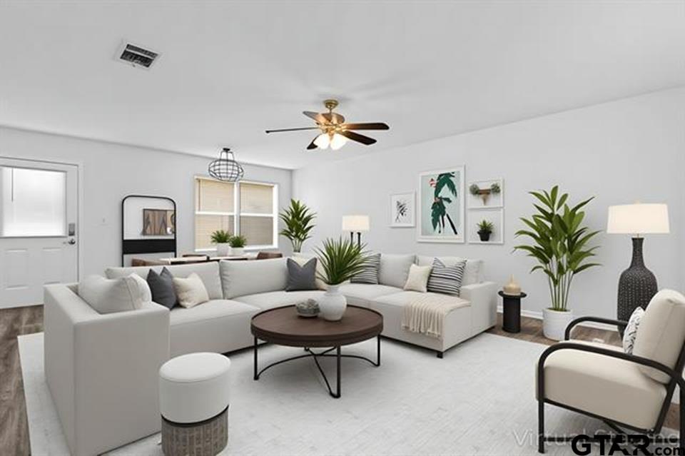 1807 Paverstone Lane Longview, TX 75605 - Photo 16 of 37 a living room with furniture a chandelier and a potted plant