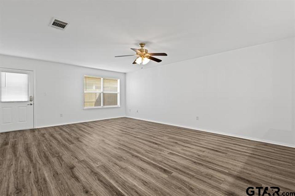 1807 Paverstone Lane Longview, TX 75605 - Photo 17 of 37 wooden floor in an empty room with a window