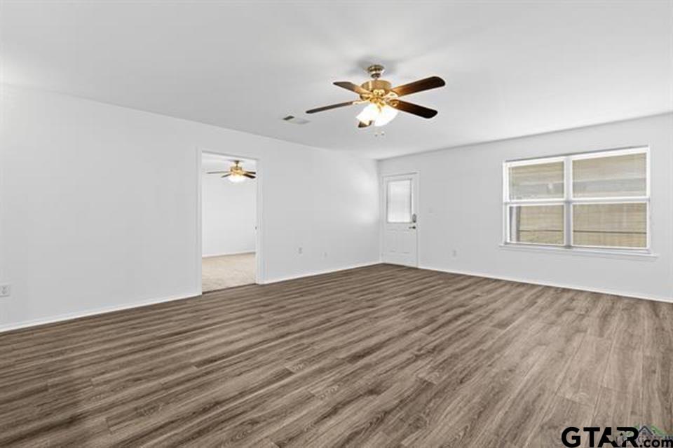 1807 Paverstone Lane Longview, TX 75605 - Photo 19 of 37 a view of empty room with wooden floor and fan