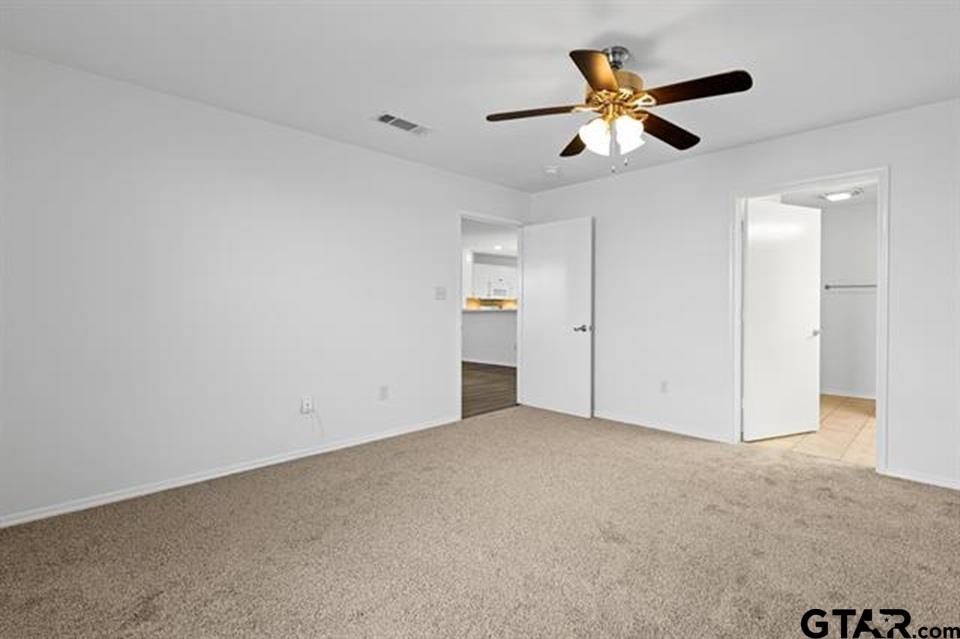 1807 Paverstone Lane Longview, TX 75605 - Photo 24 of 37 an empty room with ceiling fan and window