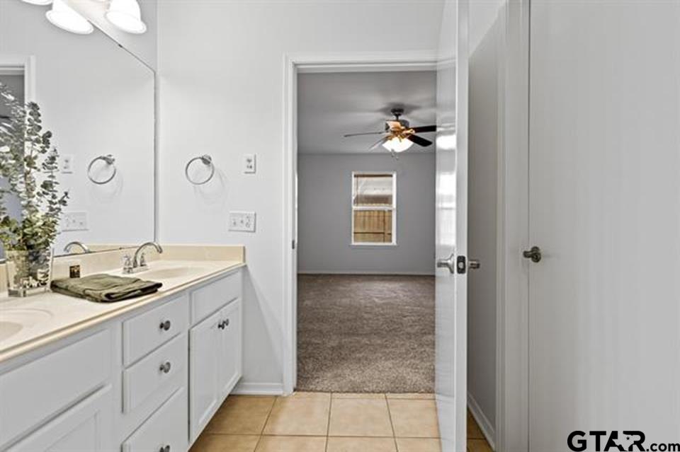 1807 Paverstone Lane Longview, TX 75605 - Photo 27 of 37 a bathroom with a sink and a mirror