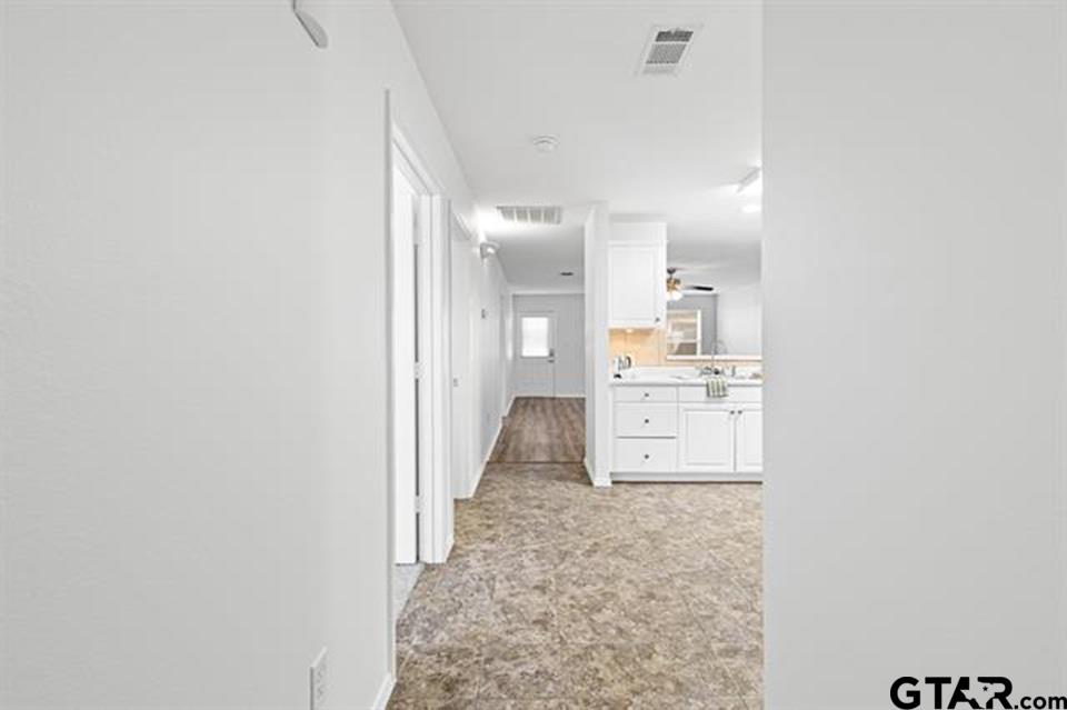 1807 Paverstone Lane Longview, TX 75605 - Photo 4 of 37 a view of a hallway with wooden floor