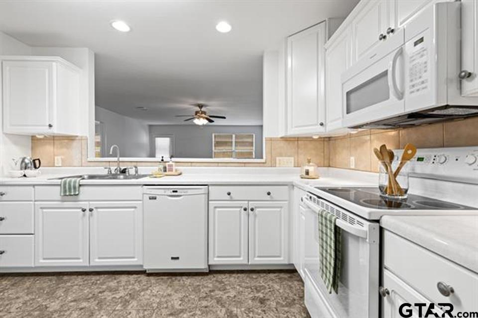 1807 Paverstone Lane Longview, TX 75605 - Photo 8 of 37 a kitchen with granite countertop white cabinets and white appliances