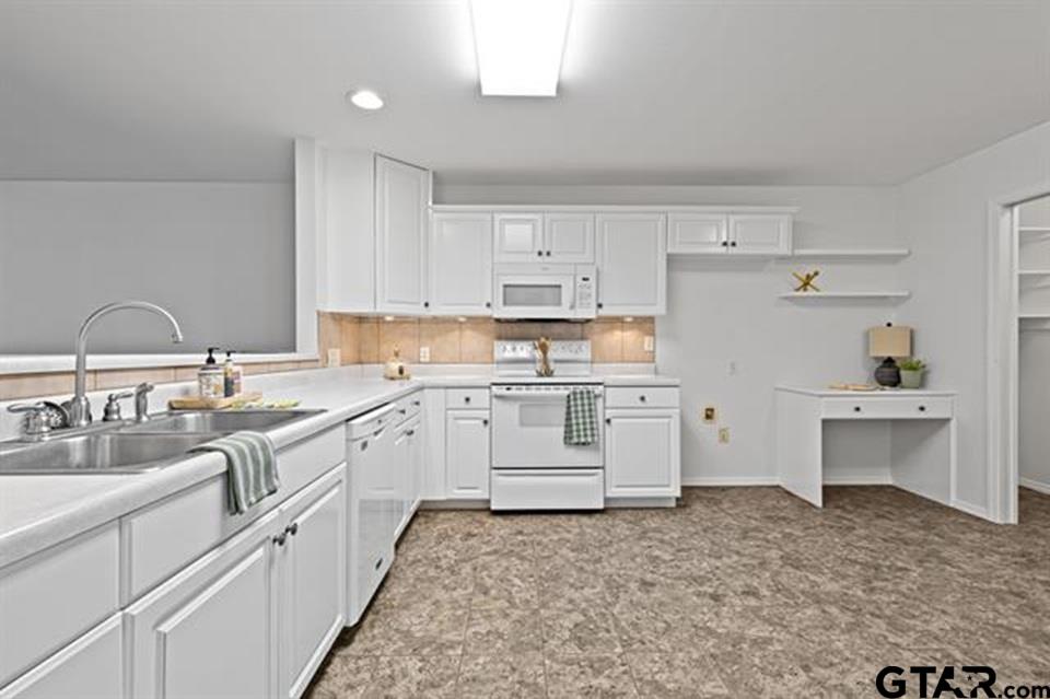 1807 Paverstone Lane Longview, TX 75605 - Photo 9 of 37 a kitchen with white cabinets and white appliances