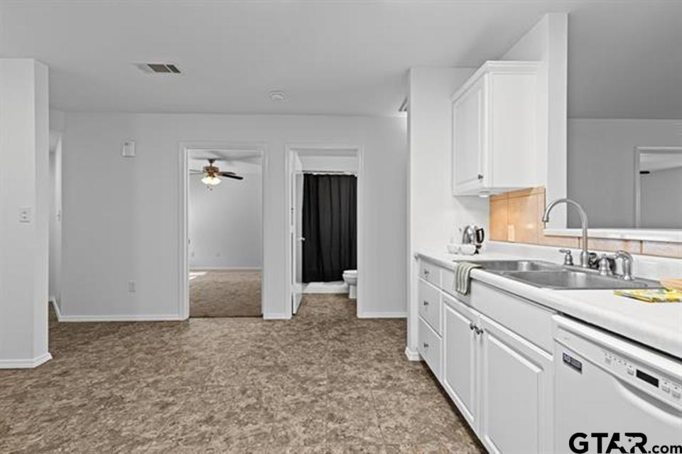 1807 Paverstone Lane Longview, TX 75605 - Photo 10 of 37 a view of a kitchen with sink cabinets and wooden floor