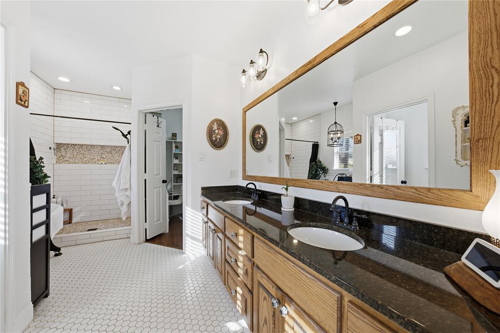 5262 Rio Vista Malakoff, TX 75148 - Photo 13 of 29 a bathroom with a granite countertop sink a mirror and shower