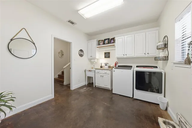 a view of a kitchen with white cabinets and white appliances