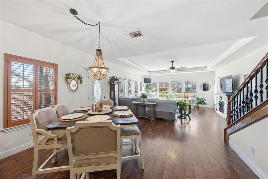 5262 Rio Vista Malakoff, TX 75148 - Photo 8 of 29 a dining room with wooden floor a chandelier a wooden table and chairs