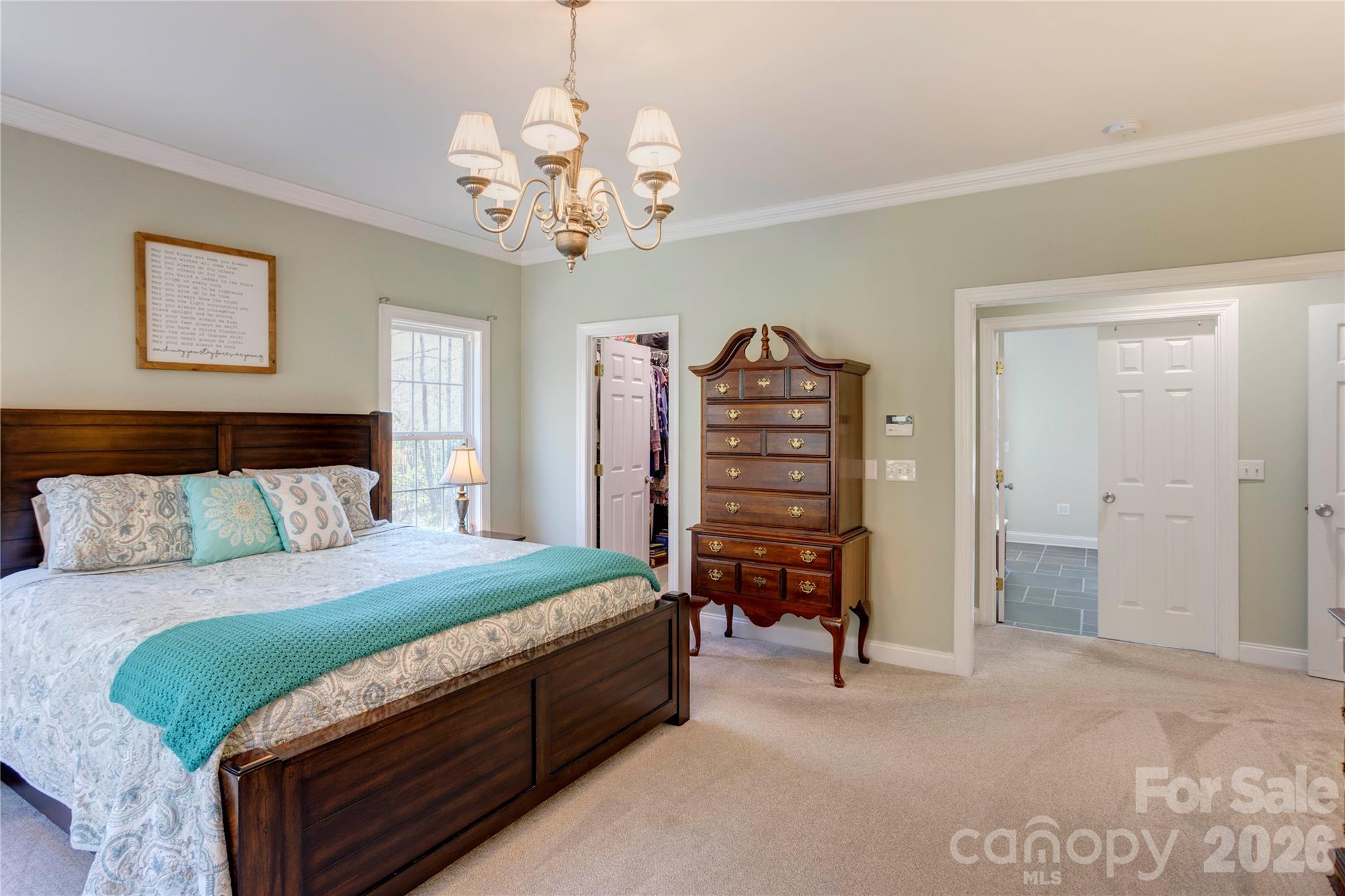 2715 Tabitha Lane Concord, NC 28025 - Photo 23 of 41 a bedroom with a bed and a chandelier