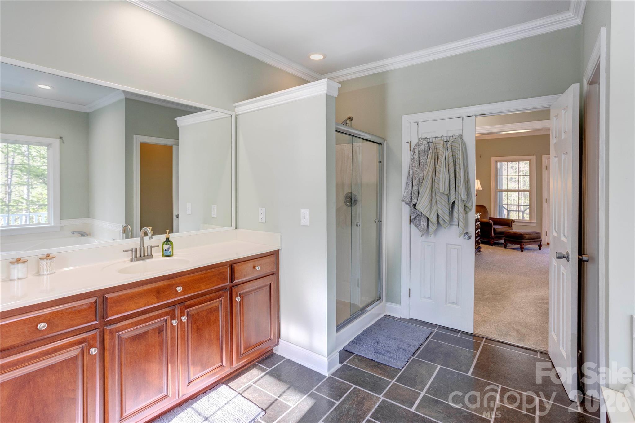 2715 Tabitha Lane Concord, NC 28025 - Photo 27 of 41 a spacious bathroom with a shower sink and mirror
