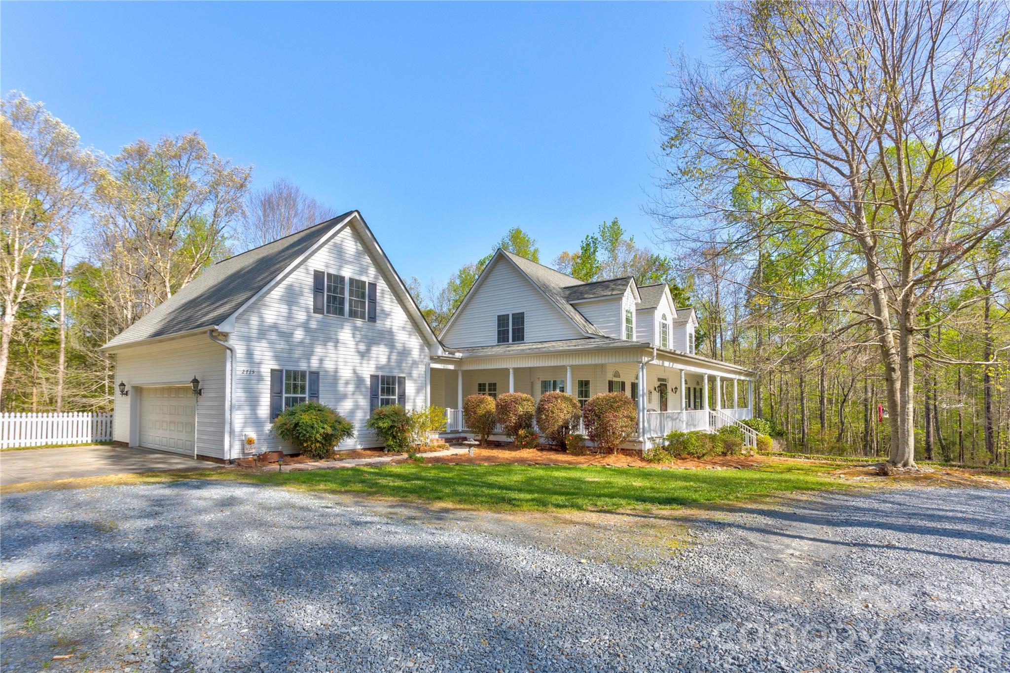 2715 Tabitha Lane Concord, NC 28025 - Photo 3 of 41 a view of a house with a big yard and large trees