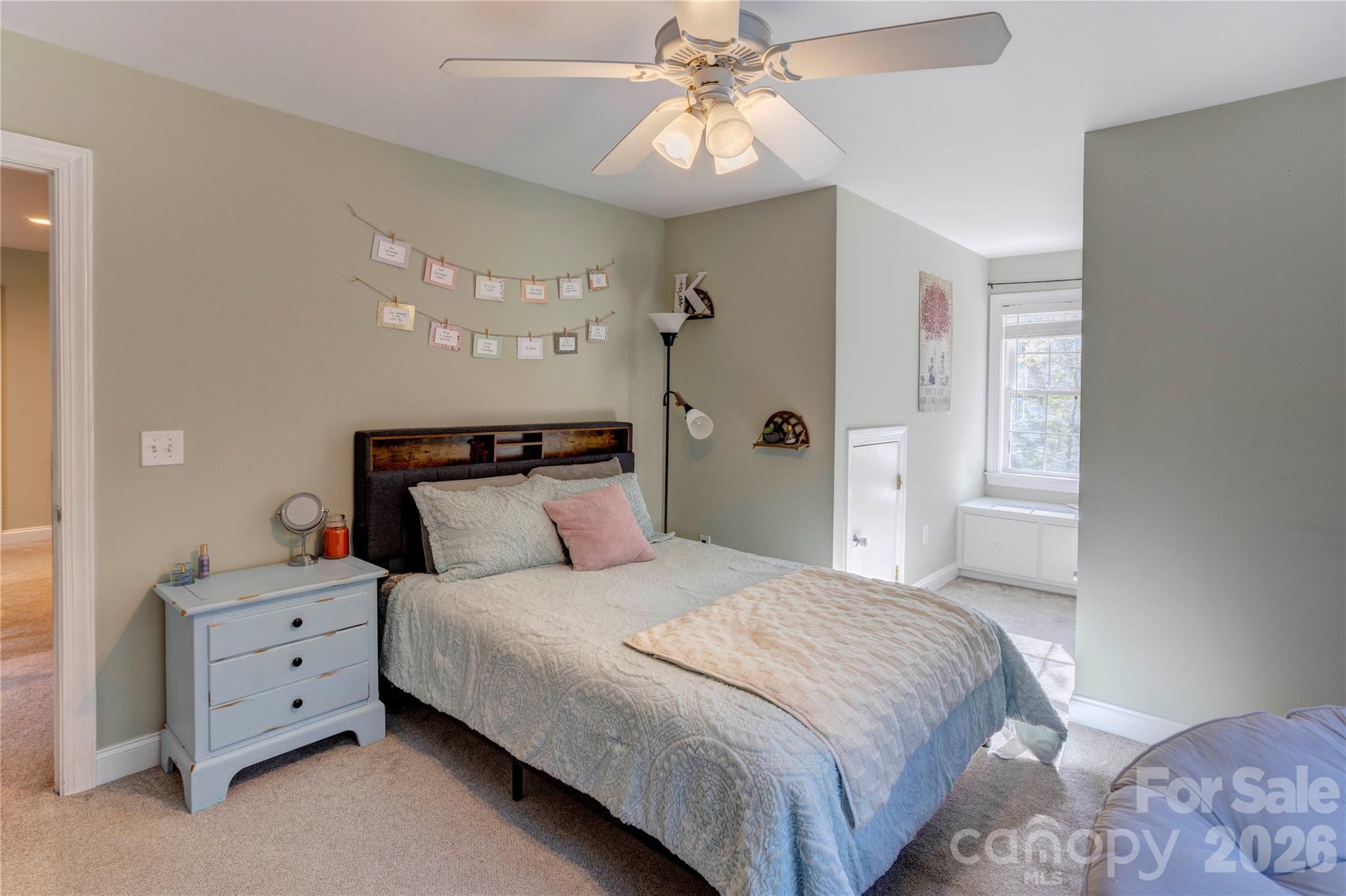 2715 Tabitha Lane Concord, NC 28025 - Photo 32 of 41 a bedroom with a bed and a chandelier
