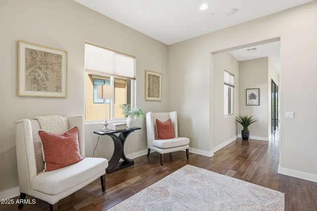 a living room with furniture kitchen and a large window