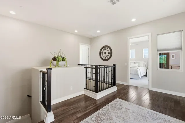 a kitchen with a dining table chairs and refrigerator