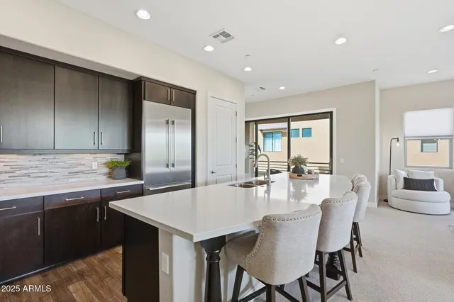 a kitchen with stainless steel appliances granite countertop a sink stove and cabinets