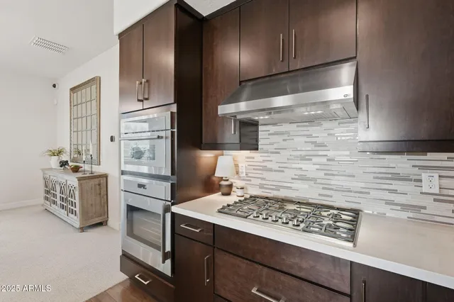 a kitchen with sink stove and dining table