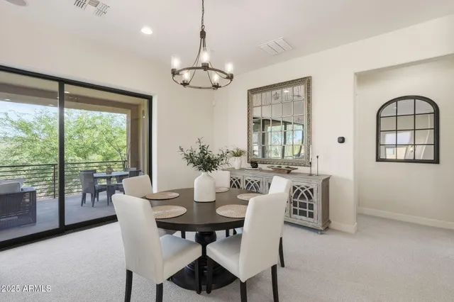 a living room with furniture large windows and a fireplace