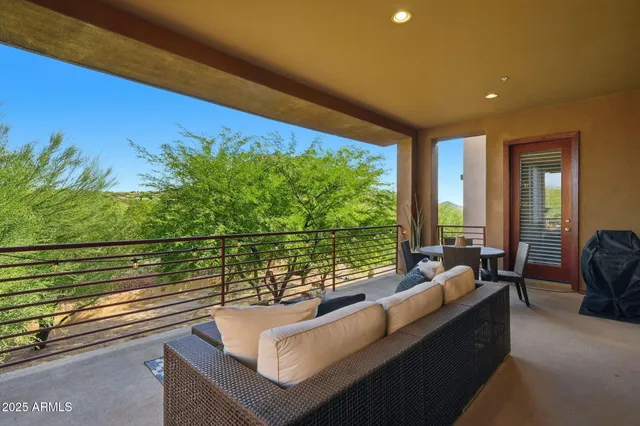 a bedroom with a bed couches and white walls