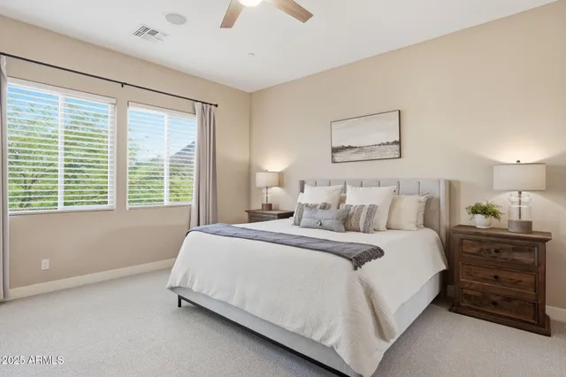 a en suite bathroom with a granite countertop sink double and mirror