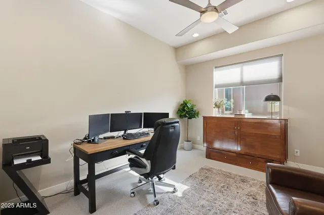a bedroom with a bed a window and dresser