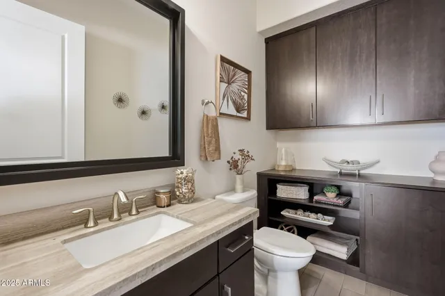 a room with a potted plant with a glass door and shower