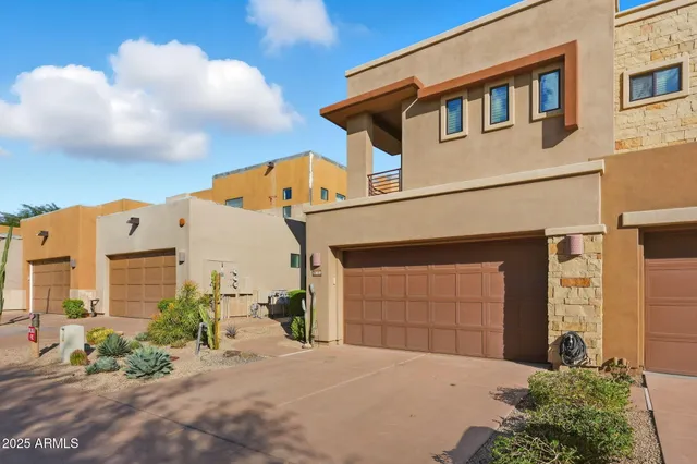 a view of a hallway with chairs and a table in a room
