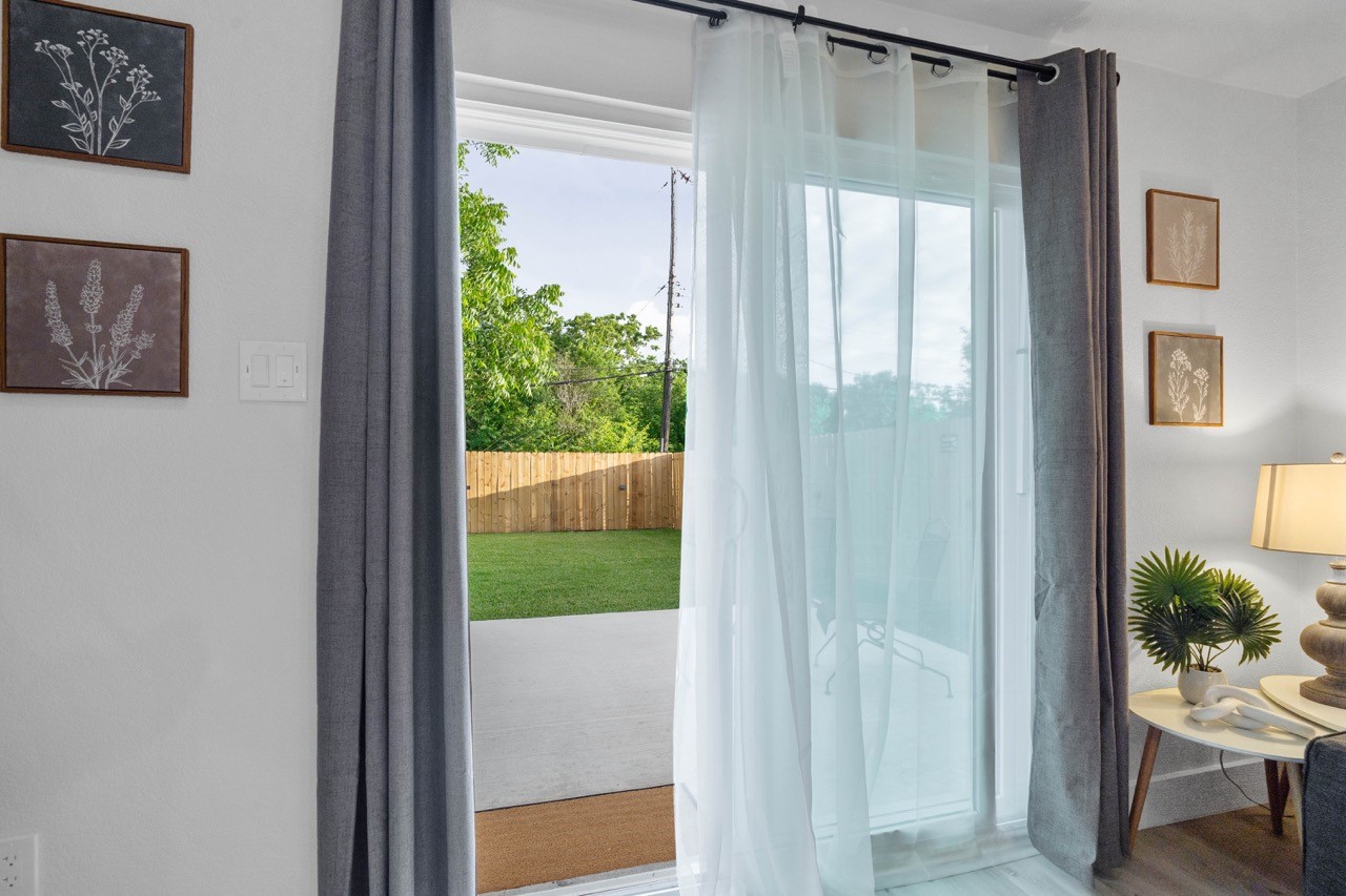 3138 Sunbeam Street Houston, TX 77051 - Photo 12 of 50 Seamless indoor-outdoor living awaits with expansive sliding glass doors opening to a spacious patio and lush backyard retreat perfect for relaxing or entertaining.
