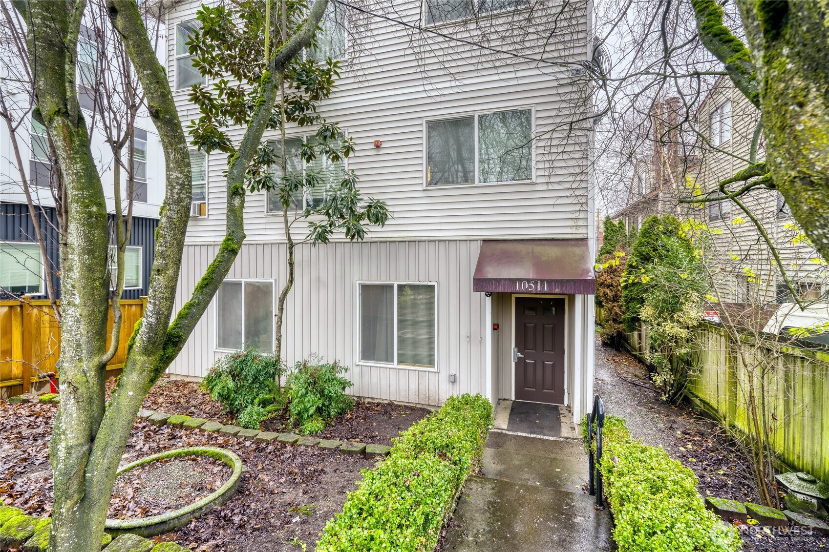 10511 Midvale Avenue North, Unit 302 Seattle, WA 98133 - Photo 1 of 24 a front view of a house with garden