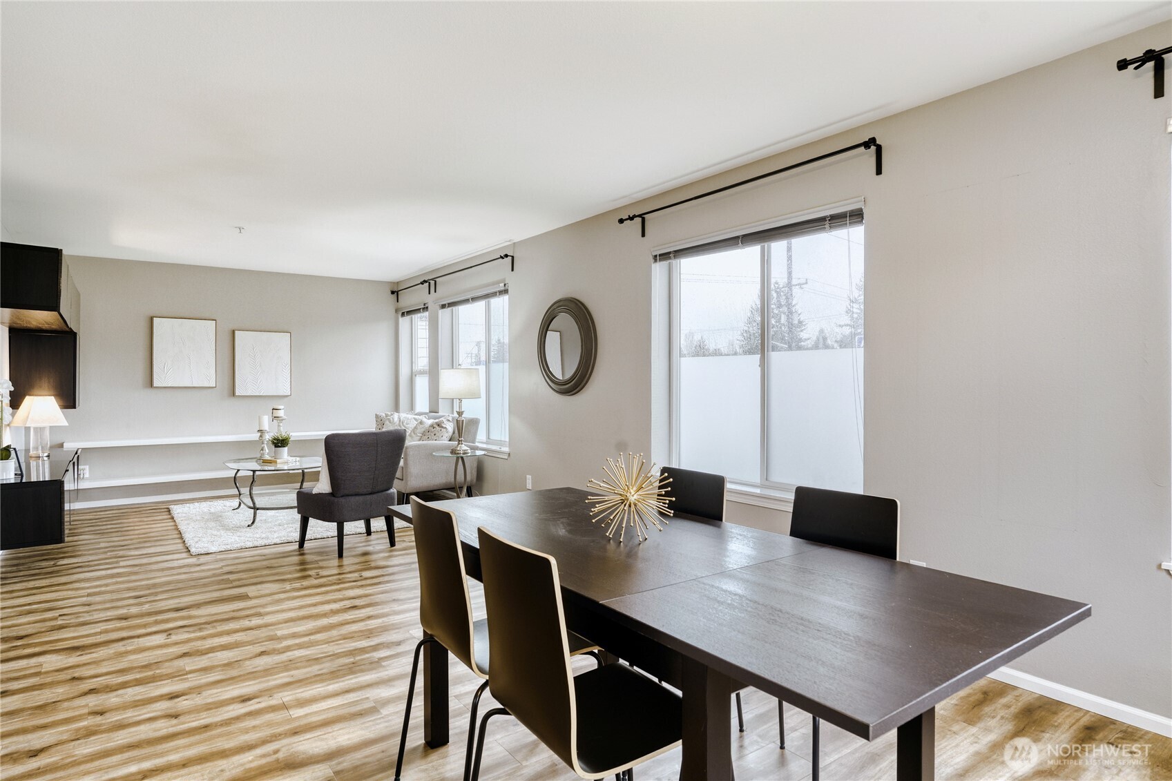10511 Midvale Avenue North, Unit 302 Seattle, WA 98133 - Photo 13 of 24 a view of a dining room with furniture and wooden floor