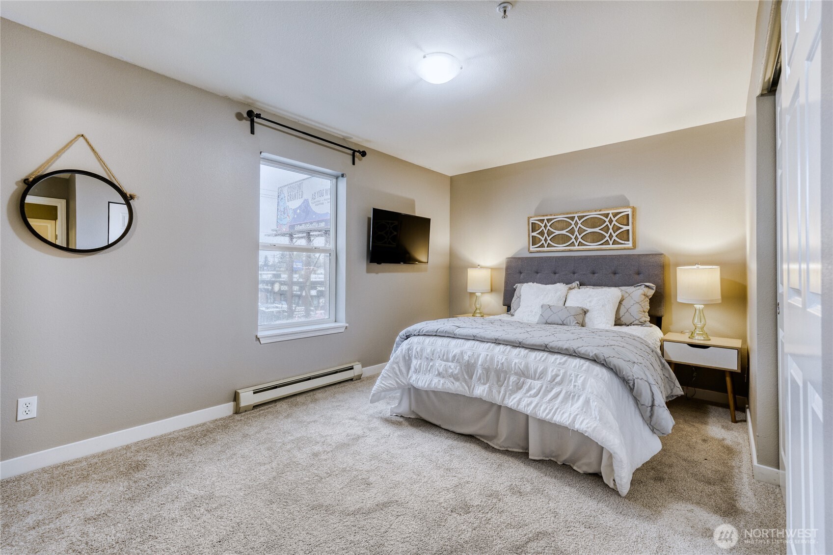 10511 Midvale Avenue North, Unit 302 Seattle, WA 98133 - Photo 15 of 24 a bedroom with a large bed and a window