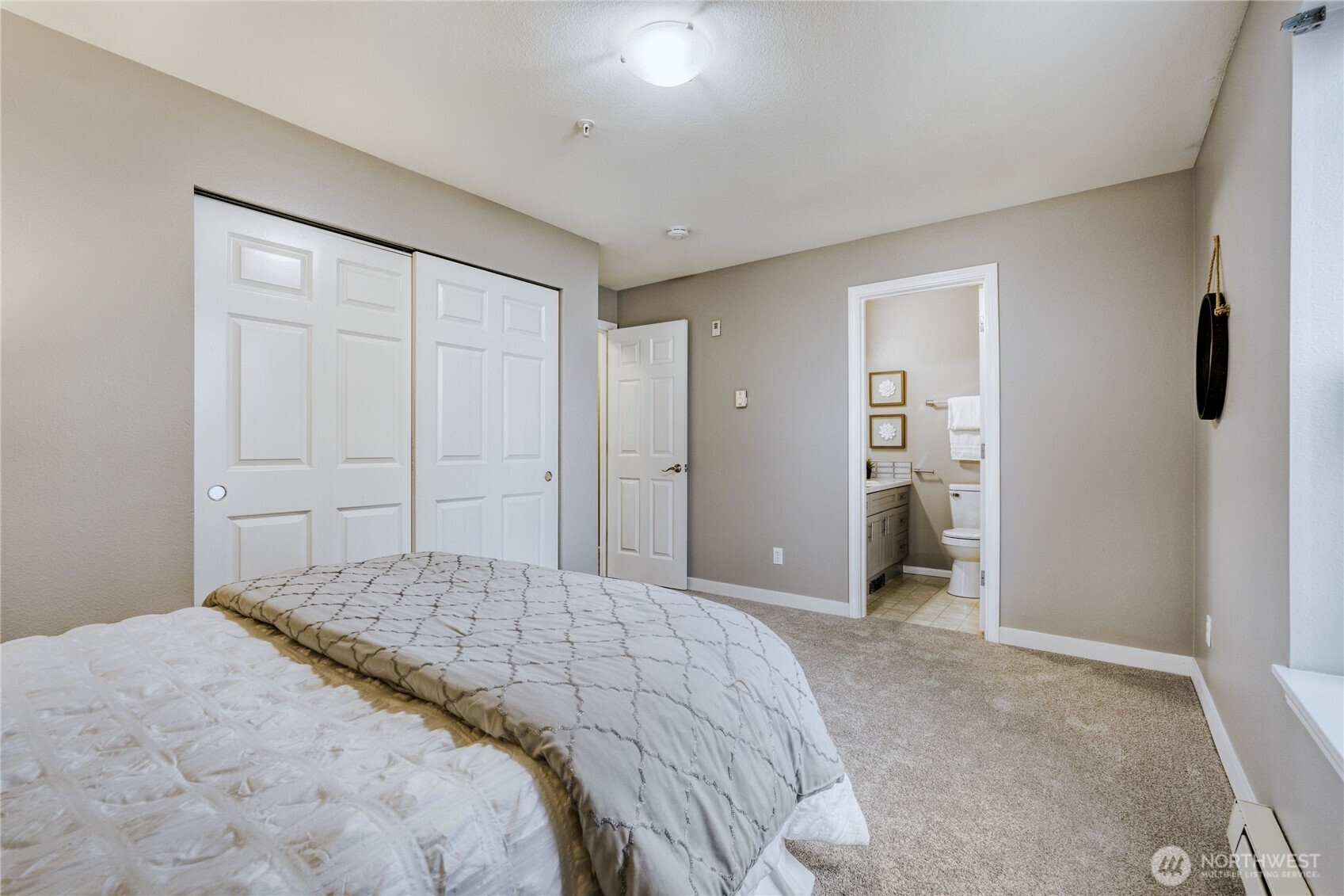 10511 Midvale Avenue North, Unit 302 Seattle, WA 98133 - Photo 17 of 24 a bedroom with a bed and closet