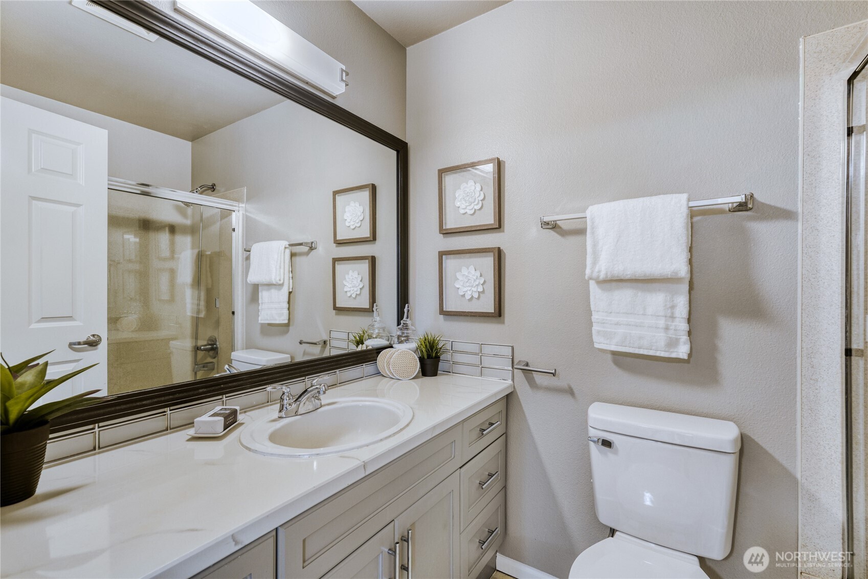 10511 Midvale Avenue North, Unit 302 Seattle, WA 98133 - Photo 18 of 24 a bathroom with a toilet sink and mirror