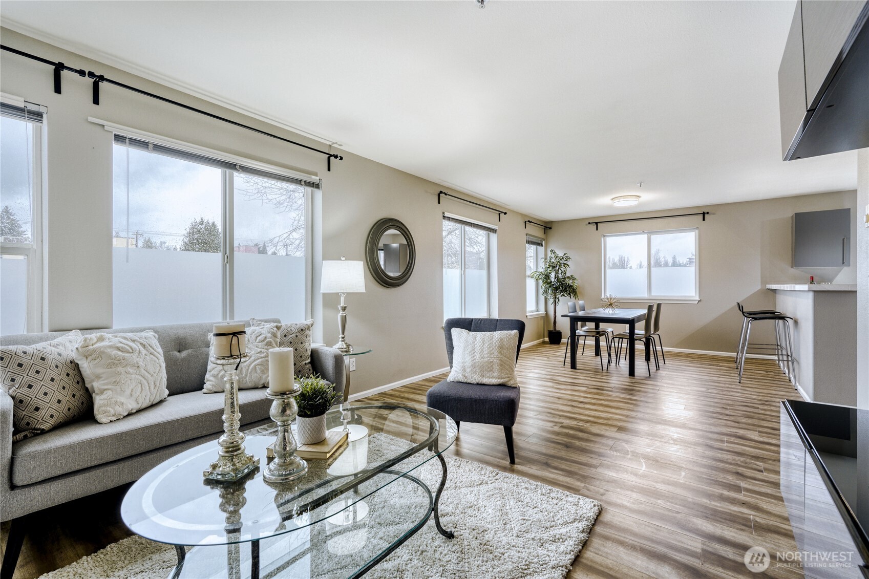 10511 Midvale Avenue North, Unit 302 Seattle, WA 98133 - Photo 2 of 24 a living room with furniture and wooden floor