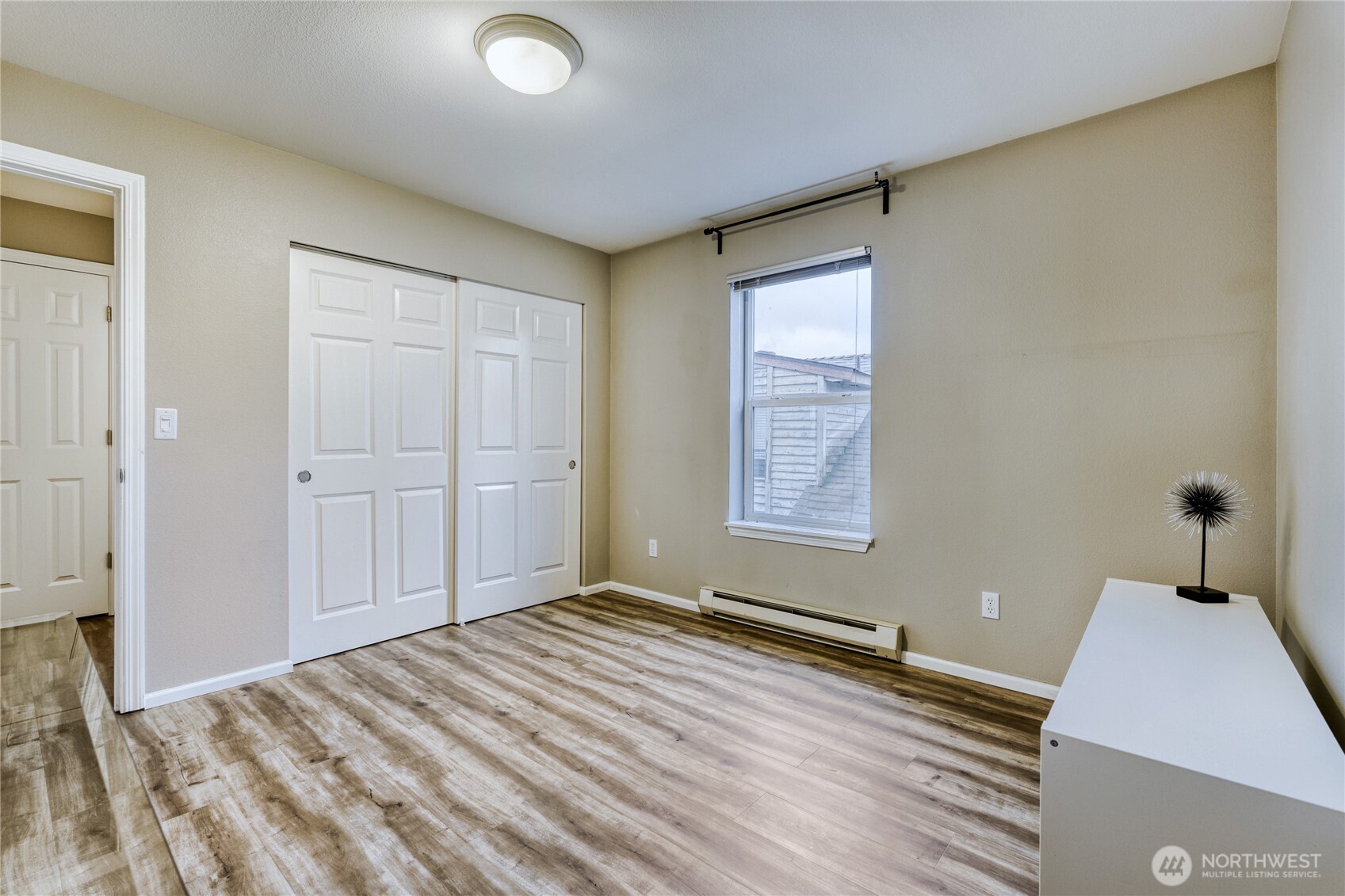 10511 Midvale Avenue North, Unit 302 Seattle, WA 98133 - Photo 21 of 24 a view of a room with wooden floor and cabinet