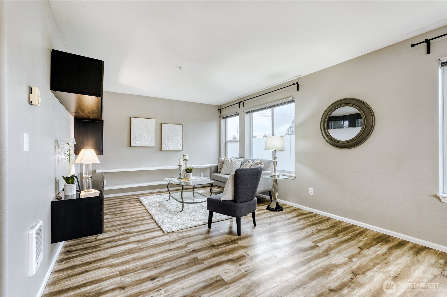10511 Midvale Avenue North, Unit 302 Seattle, WA 98133 - Photo 5 of 24 a living room with furniture and a rug