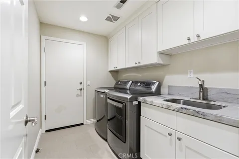 a kitchen with granite countertop white cabinets and a stove
