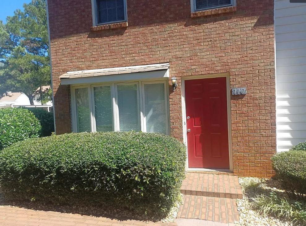 a view of a house with brick walls
